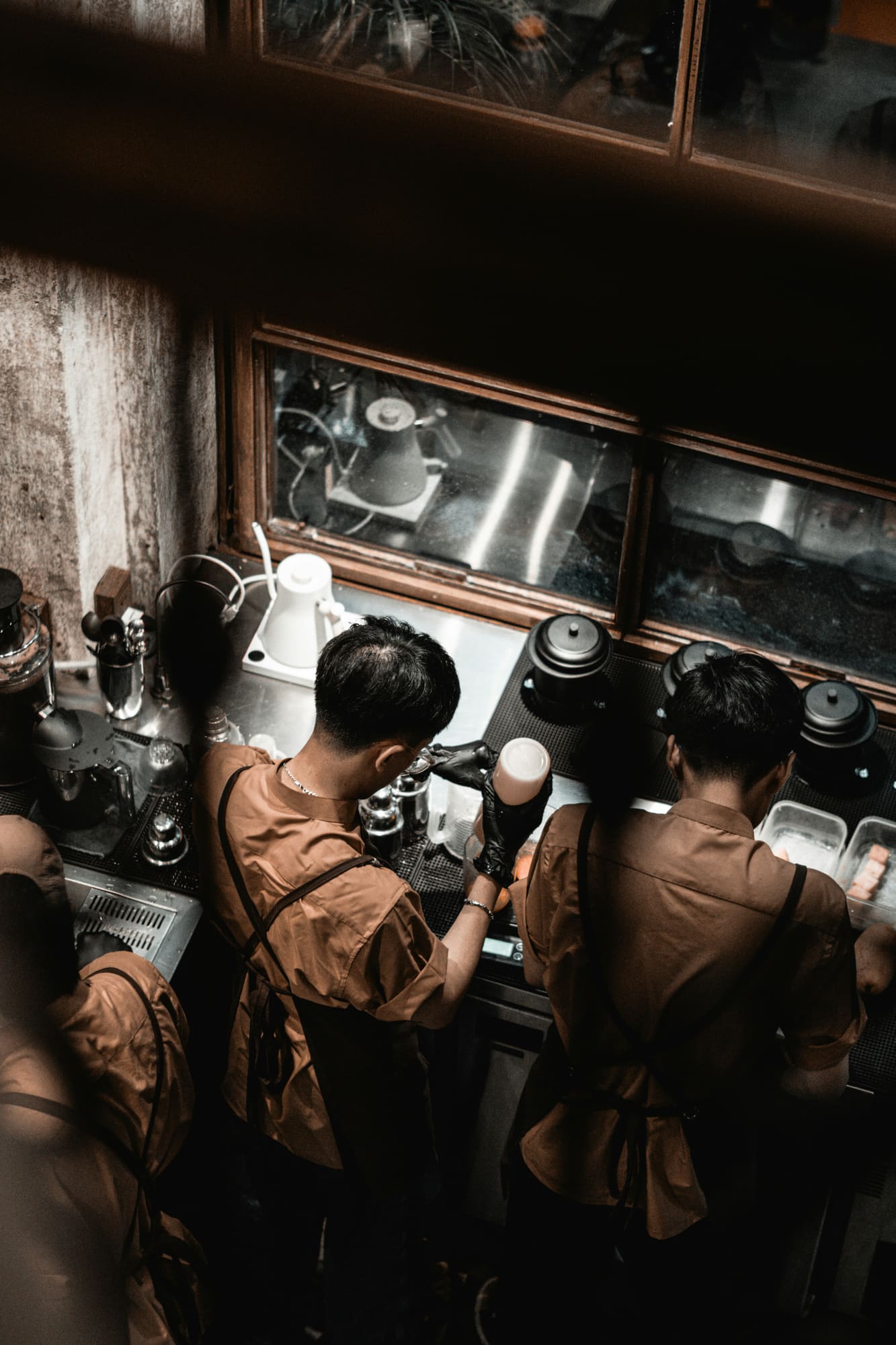 Baristas working behind a busy café counter