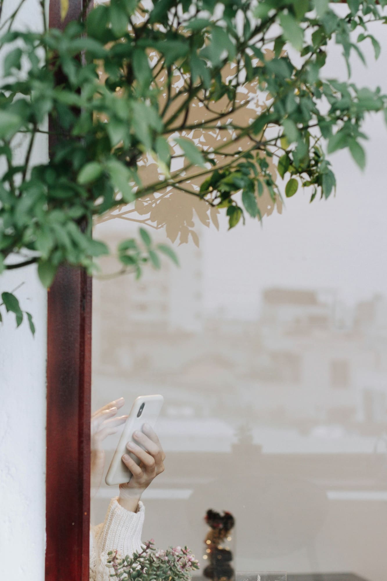 A hand holding a phone, in the customer's moment